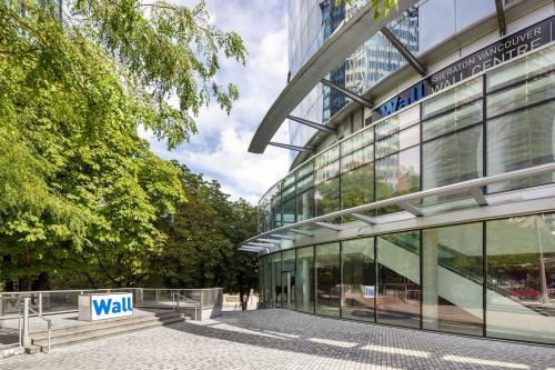 a building with a walk sign in front of it at Sheraton Vancouver Wall Centre in Vancouver