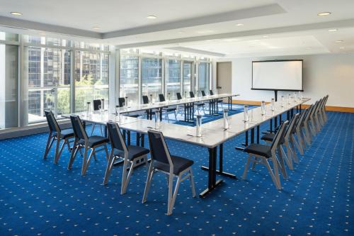 a large conference room with a long table and chairs at Sheraton Vancouver Wall Centre in Vancouver