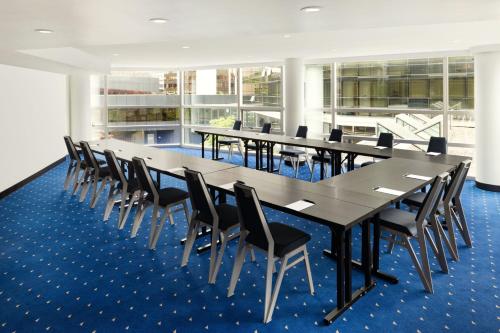 a conference room with a long table and chairs at Sheraton Vancouver Wall Centre in Vancouver