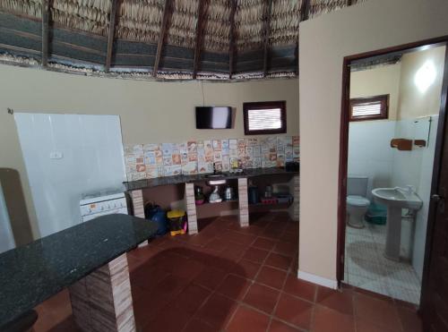 a bathroom with a fireplace and a sink and a toilet at Residência Europa in Luis Correia