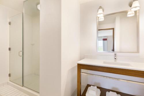 a bathroom with a sink and a shower at Four Points by Sheraton Fargo Medical Center in Fargo
