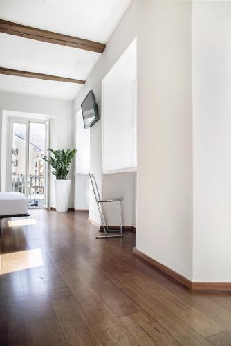 a living room with white walls and a wooden floor at Ca Bussun in Domodossola