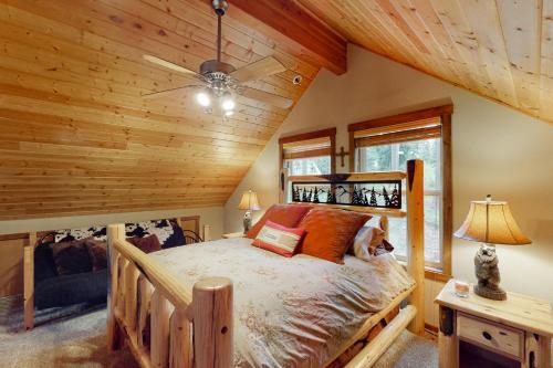 a bedroom with a bed in a room with wooden ceilings at Pine-Loch Sun Retreat in Ronald