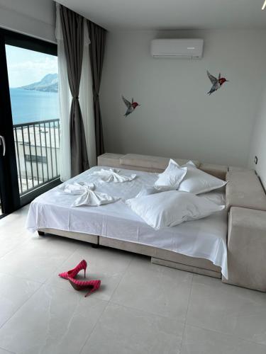 a bedroom with a bed with red shoes on the floor at Ivana&Luka-Put luke 1, Brela in Brela