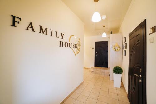 a hallway with a house sign on the wall at Family House in Vinnytsya