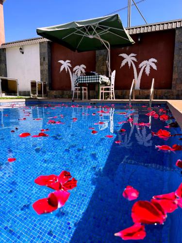 a swimming pool with red peppers in the water at Qafqaz Fountain Villa in Gabala