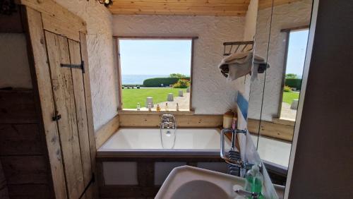 ein Bad mit einem Waschbecken und einem Fenster in der Unterkunft The Sea Shack in Ventnor