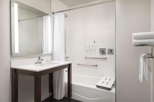 a bathroom with a sink and a tub and a shower at Four Points by Sheraton Tucson Airport in Tucson
