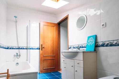 un bagno con lavandino, servizi igienici e porta di The Kitesurf Lodge a Casal do Narcizo