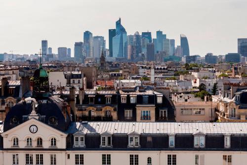 a view of a city with a clock tower on a building at AC Hotel Paris Porte Maillot by Marriott in Paris