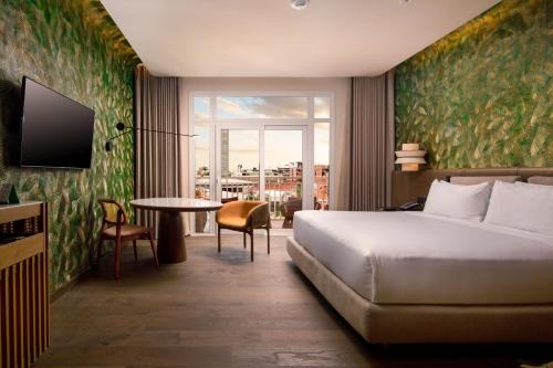 a hotel room with a bed and a table at Los Tajibos, Santa Cruz de la Sierra, a Tribute Portfolio Hotel in Santa Cruz de la Sierra