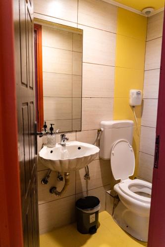 a bathroom with a sink and a toilet at Chania Hostel Youth 18-50 in Chania Town