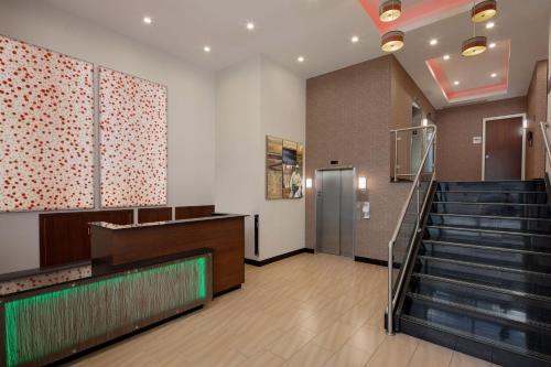 a lobby with a staircase and a stair case at Fairfield Inn & Suites New York Manhattan/Downtown East in New York