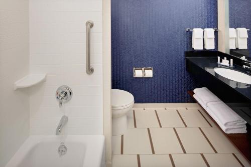 a bathroom with a tub and a toilet and a sink at Fairfield Inn & Suites New York Manhattan/Downtown East in New York