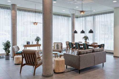 a living room with a table and chairs and a couch at Residence Inn by Marriott Hamburg Altona in Hamburg