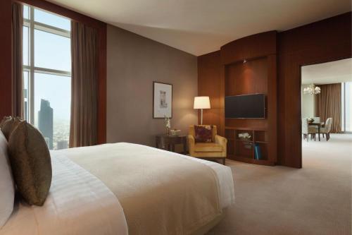 a hotel room with a bed and a television at JW Marriott Marquis City Center Doha in Doha