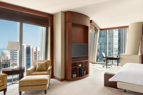 a hotel room with a bed and a large window at JW Marriott Marquis City Center Doha in Doha