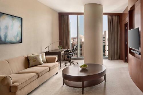 a living room with a couch and a table at JW Marriott Marquis City Center Doha in Doha