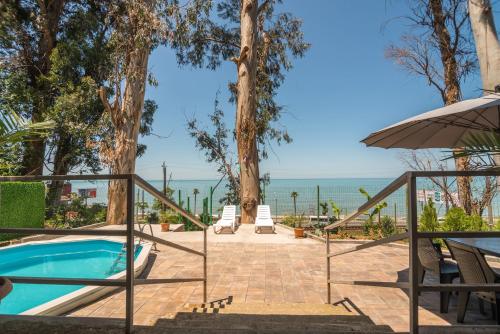 a resort with a swimming pool and the ocean at Villa Lile in Batumi