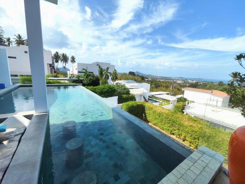 a view of a swimming pool from a house at Villa Gratia Alba in Amphoe Koh Samui