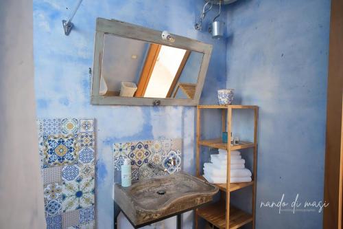 a bathroom with a sink and a mirror at Masseria Giangrande - Rooms and Apartment in Polignano a Mare