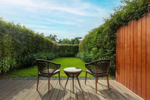 two chairs and a table on a patio at Midea Shunde, a Tribute Portfolio Hotel in Shunde