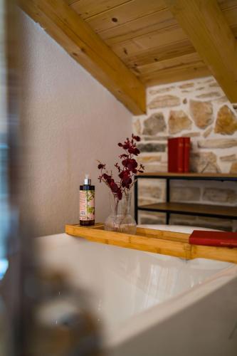 a vase with flowers in it on a counter at Stone House with pool Poeta in Pridraga