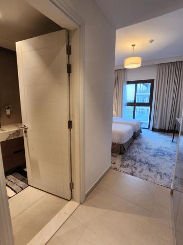 a door leading to a bedroom with a bed at Three Bedrooms Apartment at Address Residence Fujairah - AFR3203 in Fujairah