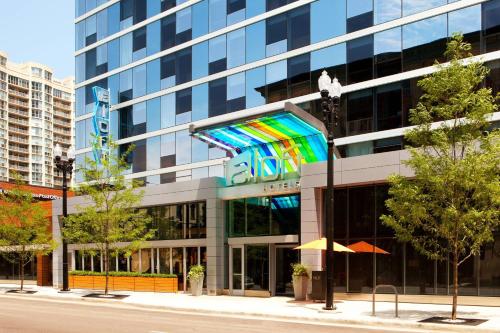 a large building with a colorful facade on a city street at Aloft Chicago Downtown River North in Chicago