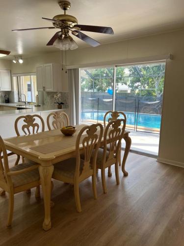 a dining room with a table and chairs and a kitchen at Airbnb rental in Miami