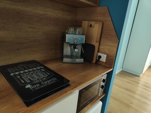 a small kitchen with a coffee maker on a counter at B&B LIBRA rooms & suite in Salerno