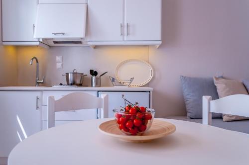 a bowl of fruit on a table in a kitchen at Milos Bay Suites in Adamas