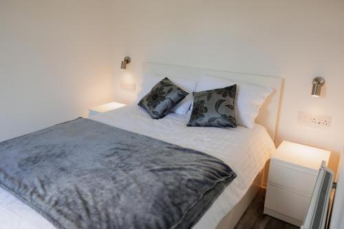 a bedroom with a large bed with two pillows at Ardvreck Chalet self-catering in Kyleakin