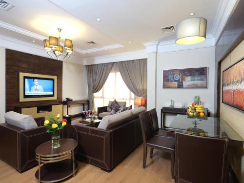 a living room with a couch and a table at Boudl Kuwait Al Fahahil in Kuwait
