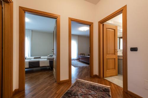 a hallway with two doors leading to a bedroom at Nonna Elvira Holiday House in Bondone