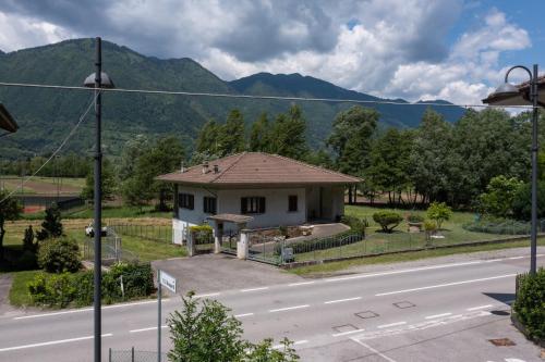 a small white house on the side of a road at Nonna Elvira Holiday House in Bondone