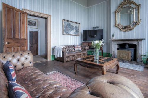 a living room with a couch and a coffee table at Rumwell Park - 8 Bedroom Manor House- Taunton in Taunton