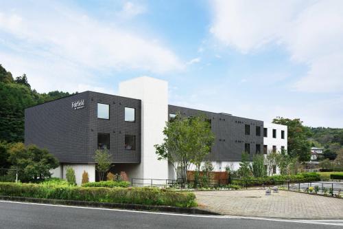 a black and white building on the side of a road at Fairfield by Marriott Tochigi Motegi in Motegi