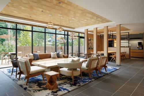 a living room with a couch and a table and chairs at Fairfield by Marriott Tochigi Motegi in Motegi