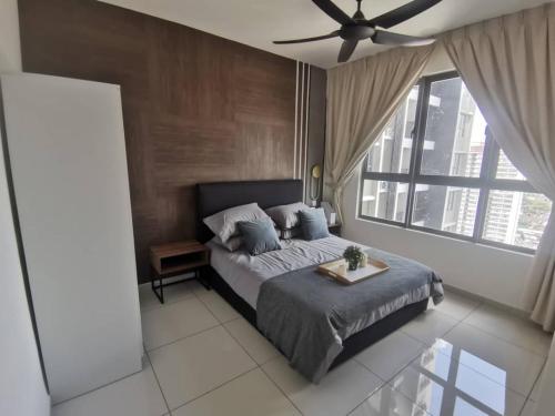 a bedroom with a bed and a ceiling fan at Mikael Homestay Kuala Lumpur in Kuala Lumpur