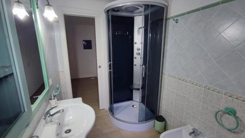 a bathroom with a shower and a toilet and a sink at Casa vacanze Tortolì in Tortolì