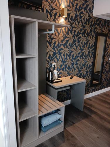 a dressing room with a vanity and a mirror at The Originals Access, Hôtel Millau Sud in LʼHospitalet-du-Larzac