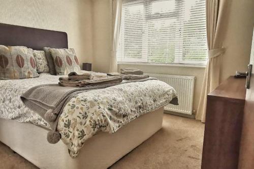 a bedroom with a bed and a window at Lakeside View in Wisbech