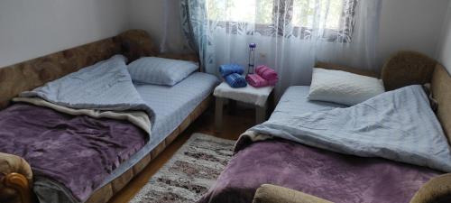 a bedroom with two twin beds and a window at 202 in Bijelo Polje