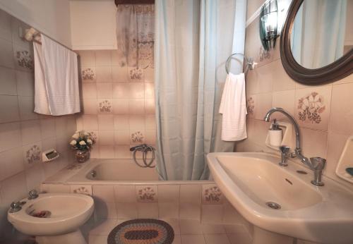 a bathroom with a sink and a toilet and a tub at Anna's House in Ayios Kirikos