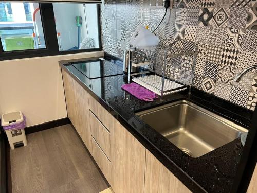 uma cozinha com um lavatório e uma bancada em Vista Bangi Apartment em Kajang