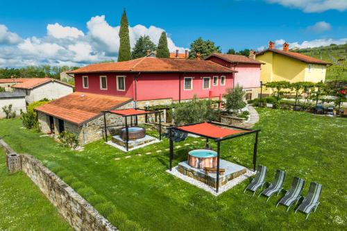 a backyard with a gazebo and a house at TouristFarm - apartments "RED FAIRYTALE" in Marezige