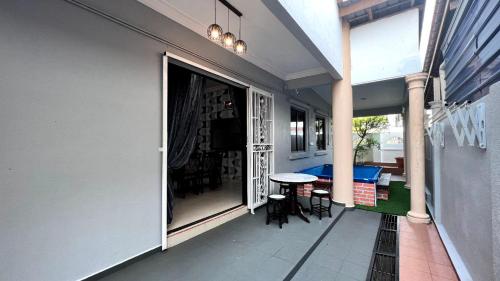 a balcony of a house with a table and chairs at YB Guest House 4 Bilik 5 Katil in Cukai