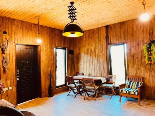 a dining room with a table and chairs at Cottage in Racha Khoteura in Ambrolauri