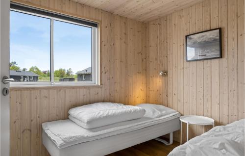 a small room with a bed and a window at Beautiful Home In lbk With Kitchen in Ålbæk